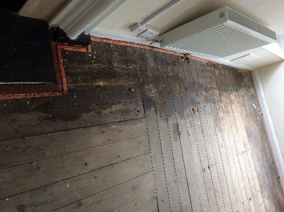 Dartmouth Town Council: Damp stains on floor boards after the carpet was pulled up