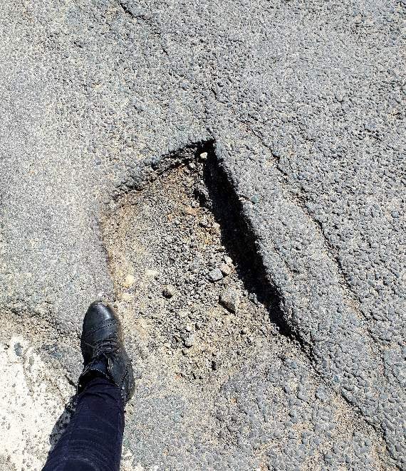 The pothole it warns you about (with my foot for scale, size 6)