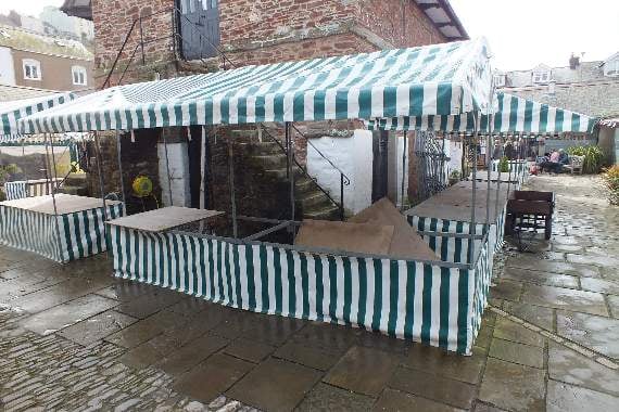 The double market stall after it was lifted off the man and put back upright