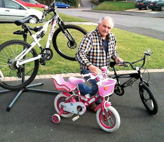 Andrew and some of the bikes in the renovation stage, including the mountain bike and child’s pink bike