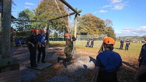 Cadets practicing their teamwork and communication skills on BRNC’s low-ropes course