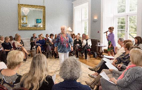 Treasurer and trustee of Friends of Dementia Friendly Parishes around the Yealm, Jacqui Avery, strutting her stuff on the catwalk as attendees ooh and ahh at the outfits (Credit: Terry Edgson)