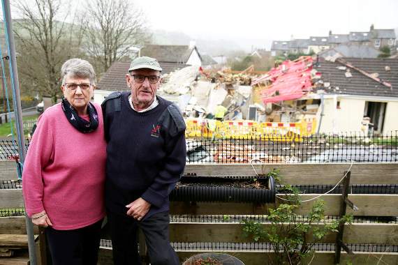 Neighbours Victor and Pauline Manfield who were brushing their teeth when the bungalow exploded in Buckfastleigh. Pauline, 75, said: “There was just this massive bang. It made the house shake for a good few seconds. “My husband thought a plane had come down. “There was this gust of smoke. I went to the window and saw her hair all singed off which I don’t understand because there wasn’t a fire. “She normally has blonde hair but mind you she doesn’t have much of that left. “A young man who just so happened to be walking past ran over to help her and took her for a cup of tea at a neighbour’s house. “She was in her night dress and panties. Apparently she was brushing her teeth at the time. “Jean, who lives next door to her had her water tank fall on her. I am just so shocked that she is still here and she is still alive.”