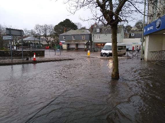 Deep water slowing traffic outside of Kingsbridge Bus Station