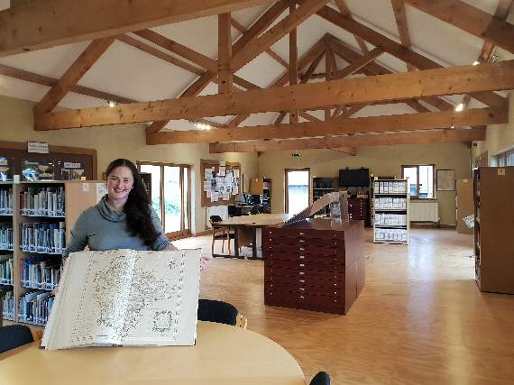 Abi Gray, the lead archaeologist at the Devon Rural Archive, with the 1765 map by Benjamin Donn