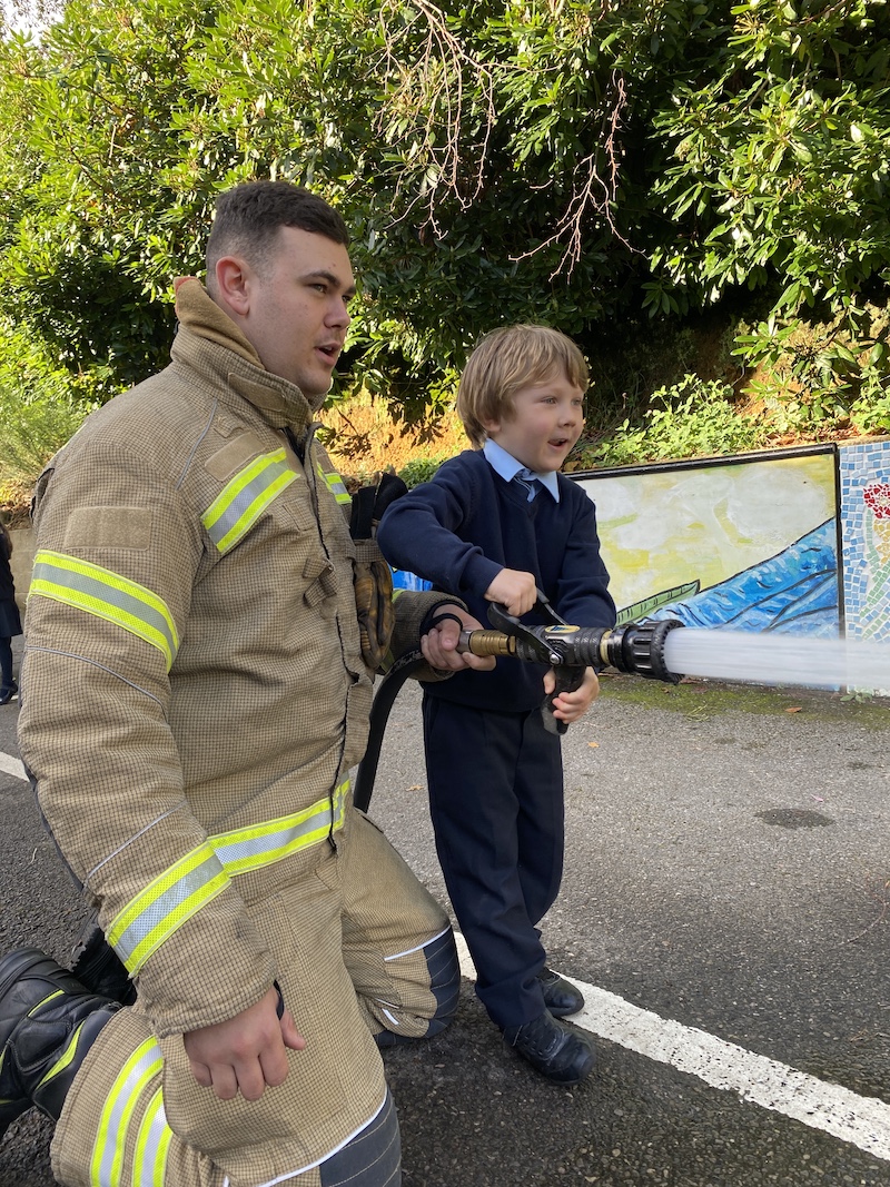 A St Ives School pupil squirts the hose