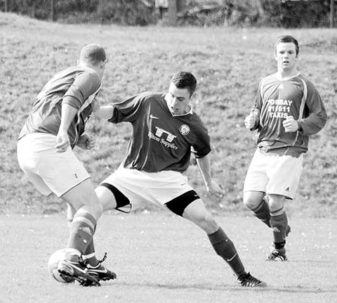 Mark Williams for Chagford gets stuck in against Hele Rovers. Picture by abphotographic.com