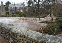 Waters two-feet deep flood the village of Peter Tavy