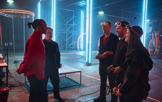 James (third from right) is pictured during filming for the Vodafone UK drone video with fellow drone flyers Kelsey Hunt and Shane Hedges (right and second from right) and Formula 1 world champion Lewis Hamilton (left). Picture by ‘WeAreSocial’.