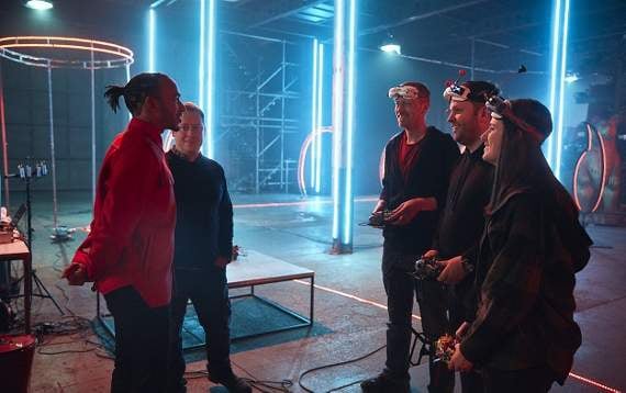 James (third from right) is pictured during filming for the Vodafone UK drone video with fellow drone flyers Kelsey Hunt and Shane Hedges (right and second from right) and Formula 1 world champion Lewis Hamilton (left). Picture by ‘WeAreSocial’.