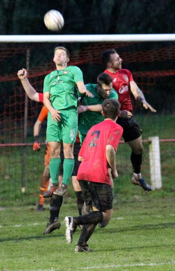Callington Town (in red and black) defend their goal-line from visitors Falmouth. Pictures by James Bird