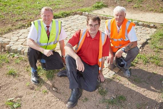 Archaeologist Chris Caine, who was involved in the dig, site manager Steve Smith and groundworker Phillip Lang on the Romansfield site with the newly reconstructed piece of the Roman road discovered at the site.