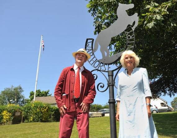 Sir Michael Morpurgo with the Duchess of Cornwall by the War Horse sign in Iddesleigh
