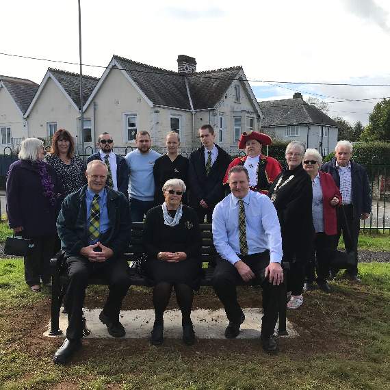 June Trevithick with sons Richard and Paul on the bench in memory of John, surrounded by other family and town councillors