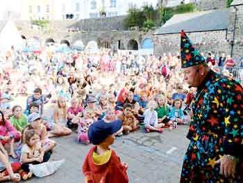 Magician Philip Jones with a young helper.