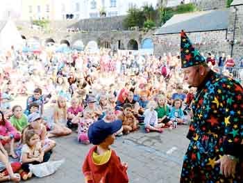Magician Philip Jones with a young helper.