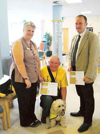 Leo and Colin being presented with a certificate in recognition of their volunteering by David Fretwell, head of volunteering services, and Tilly Morrissey, resource centre manager.