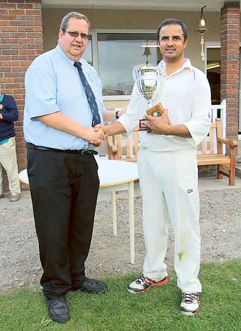 Kashif Ijaz of Haverfordwest receives his Man of the Match Award from Richard Merriman.
