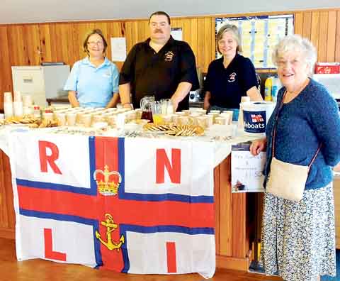 RNLI Angle open day Welsh cakes, tea and coffee are served by Pembroke Ladies Lifeboat Guild members Rosie Allen-Mirehouse (Guild president and RNLI Angle deputy launching authority) and Emma Geear. With them is RNLI Angle shore crew member David Jones and visitor Mrs. A. Heath, of the Carmarthen RNLI Branch. Photo: Pembroke Ladies Lifeboat Guild.