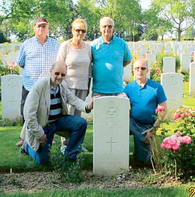 Paying tribute at Wing Commander Reg Baker’s grave are, back row: Derek Church (left), Sue and Graham Clarkson. Front: John Evans and Martin Blow (right).