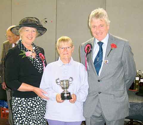 Susan McKehon receives the B. R. Munt Perpetual Challenge Cup for the Best Black and White Print in Show for the second year running from show president R. Ll. Davies BA (Hons) and his wife Margaret.