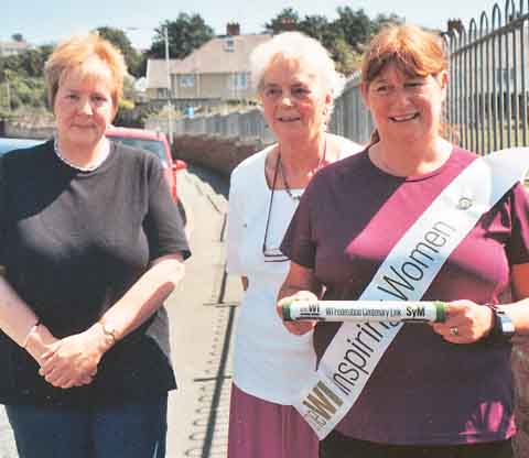 From left: Jayne Smith, Margaret Brown and Pauline Charlett with the baton.