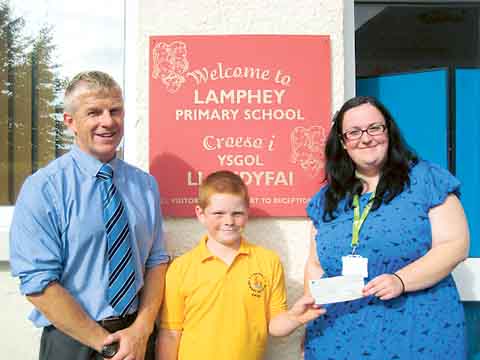 Dylan presenting the cheque to Ty Hafan.