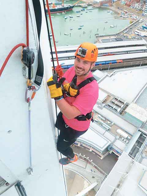 Angelo abseils down the Spinnaker Tower for Brain Tumour Research.