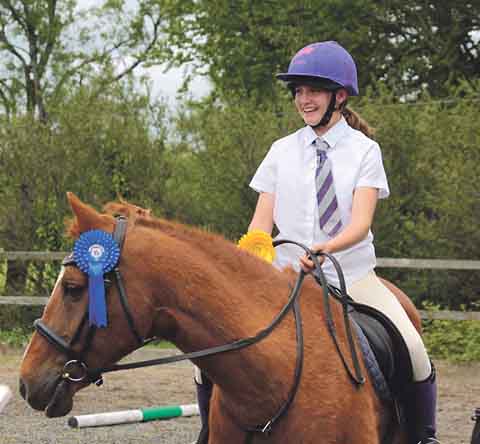 Cody Bridgeman with Dudley showing off their 1st Rosette (Pony Club has 1st rosette as blue instead of red!).