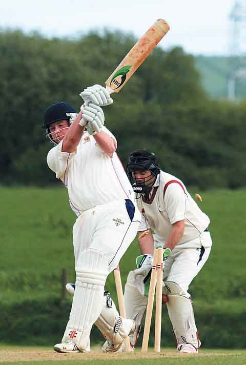 Tom Murphy takes a valuable wicket bowling Tom Davies of Carew.