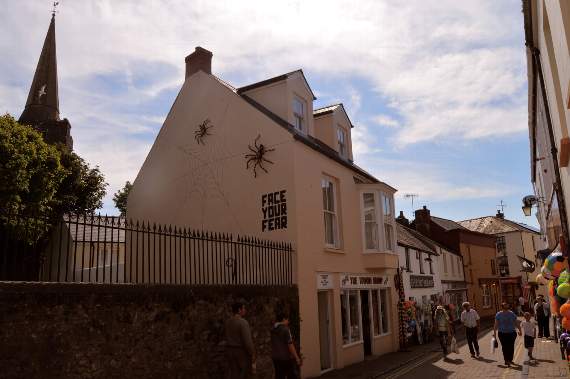 The spiders and slogan can be spotted on the side of the Wood Shop in Tenby.