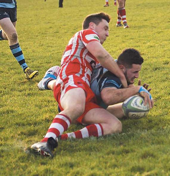 Jack Price brought down by an Emlyn defender. Pic. Elwyn Davies