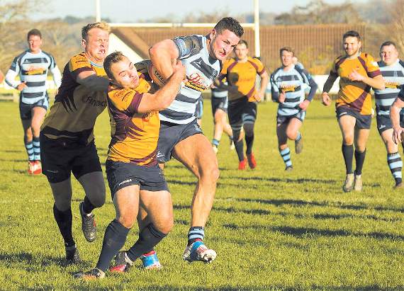 Jack Price wrestling the ball from an opponent. Pic. Elwyn Davies
