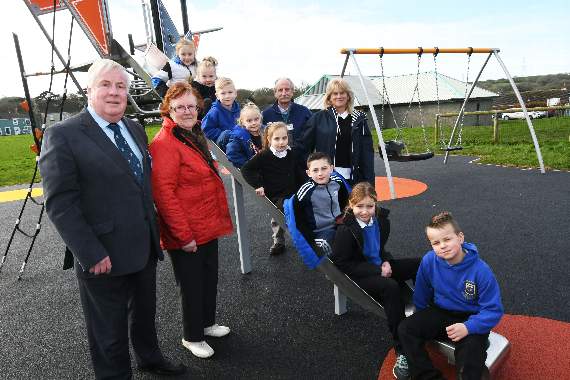 Pupils from the nearby Monkton Priory School are pictured ‘road testing’ the new play equipment with learning support assistant Louise George. They are watched by county council deputy leader, Keith Lewis, Clr. Llewellyn and David Phillips, the council’s play area inspector.