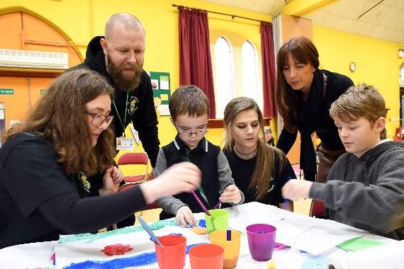 Pictured are volunteers Lottie Dessent and Cerys Edwards with club members and inclusion service staff Jonathan Bell and Hayli Gibson (standing).