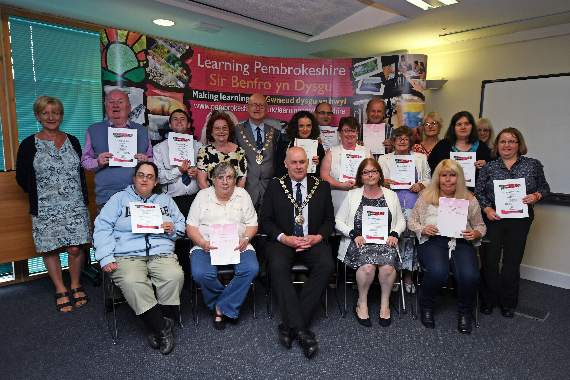 Essential Skills learners in maths and English are pictured with their certificates.