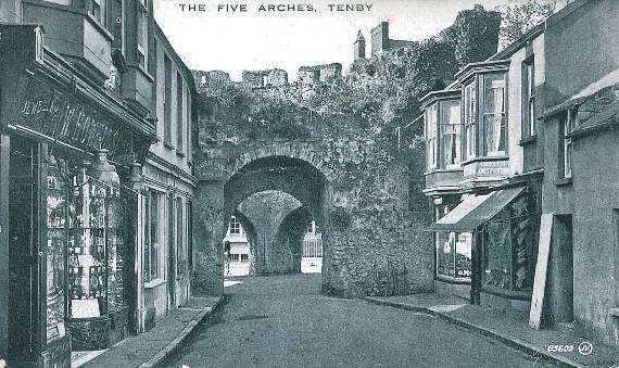 Above is a view of the Five Arches from St. George’s Street, with William Howells’ jewellers on the left and a ladies/gents outfitters called ‘My Hatter’ on the right. The Valentine’s Postcard was sent from Pembroke Dock to Miss M. Mason, 102 Rosebank Avenue, Sudbury Hill, Harrow, Middlesex, on September 13, 1926. The message reads: “Dear M. I suspect you have heard that I shall be with Ted soon. I am going to stay a few days with Mrs. Petty at 34 Wormhalt, Shepherds Bush Road, so if there is any chance of seeing you write me there. I hope to arrive Paddington at 615 p.m. Wednesday. Hope all are well. Yours E. Dew.