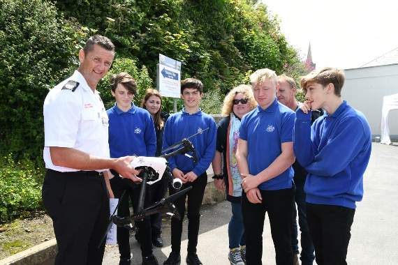 Ady Smith from the Fire Service showing pupils the drone used to search the coastline during emergencies.