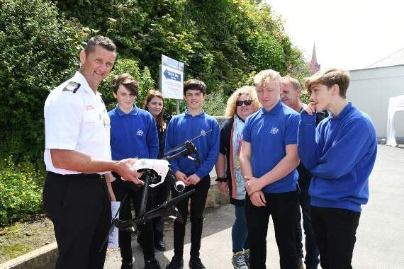 Ady Smith from the Fire Service showing pupils the drone used to search the coastline during emergencies.