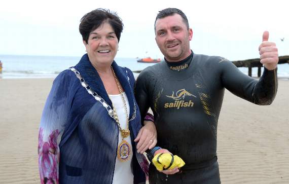 The first swimmer home, Hayden Johns, of Tenby, is congratulated by town Mayor, Clr. Mrs. Sue Lane.