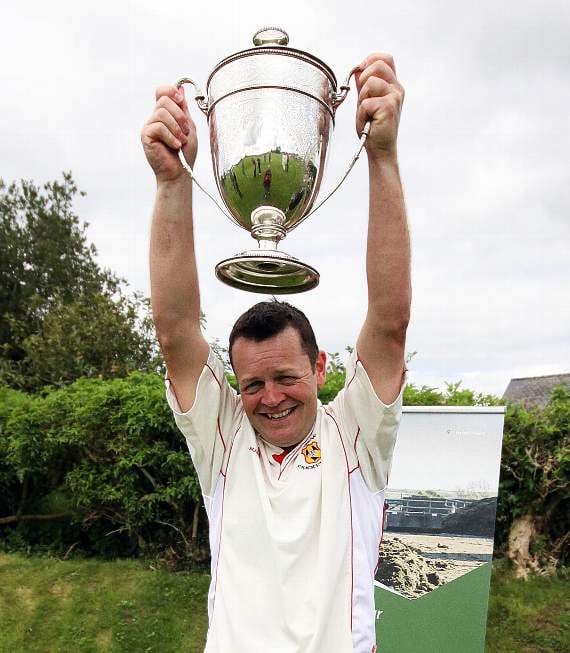 Carew Captain Brian Hall holds the Division I Championship Trophy aloft (Pic. Susan McKehon)