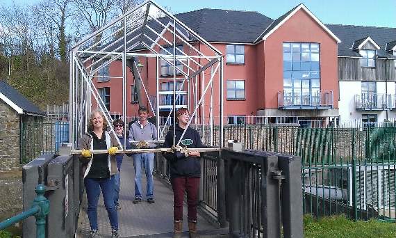 A greenhouse was donated and caused much joviality as it was carried through Pembroke to its new home.