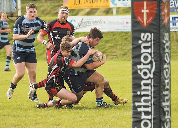 Bradley Davies being brought down by some desperate opposition defenders. Pic. Elwyn Davies