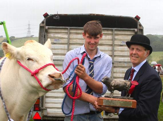 The president, Edward Morris, presents Robert Coney with an award for his winning Charolais heifer.