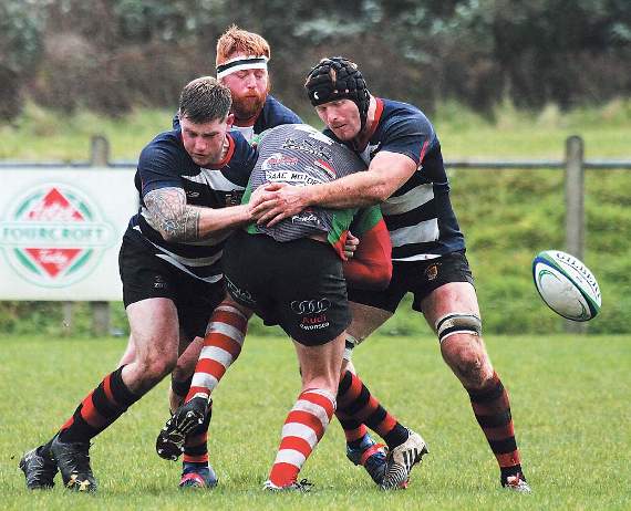 Andrew Cooke, Robbie Clarke and Roy Osborn combine to halt the Gorseinon attack. Pic. Susan McKehon