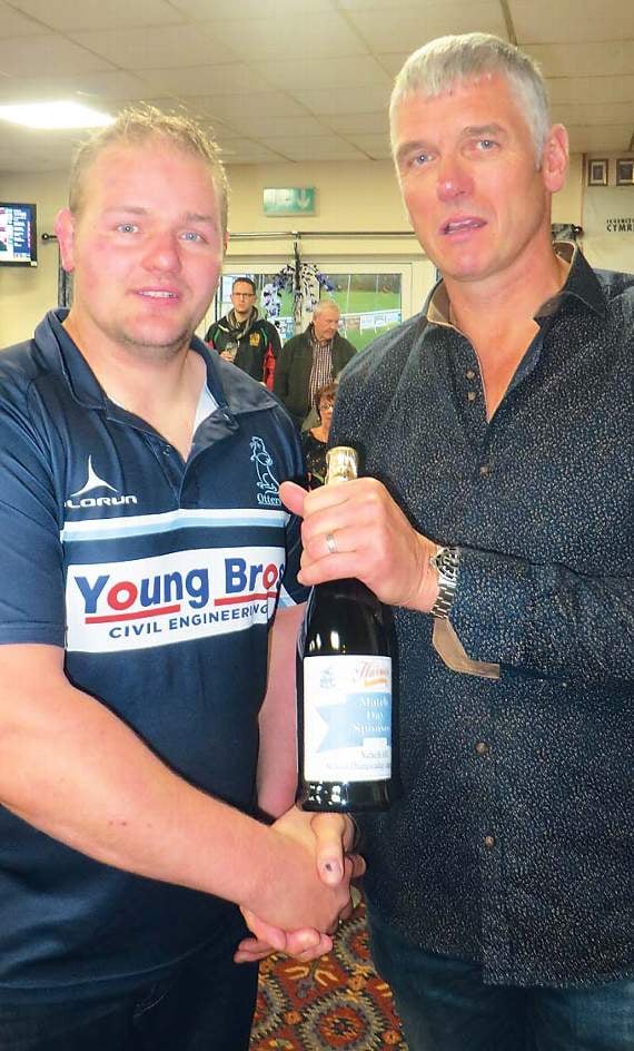 Bill Ridge, sponsorship officer, hands Tom Slater, of The Glen, Haverfordwest, a bottle of G. D. Harries bubbly as a thank you for being the Hywel Griffiths Plant Hire Balcony Suite match sponsor. Pic. Stephen Thomas