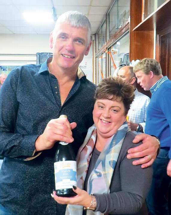 Birthday boy Bill Ridge gives Janet Phillips, of G. D. Harries, a bottle of bubbly as a thank you for being the Otters Holt sponsors. Pic. Stephen Thomas