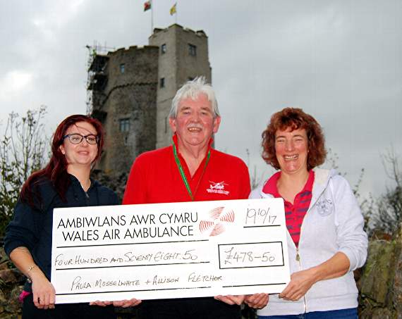 Alison Fletcher (left) and Paula Musselwhite are seen presenting their cheque to Wales Air Ambulance fundraising co-ordinator Tony Key.