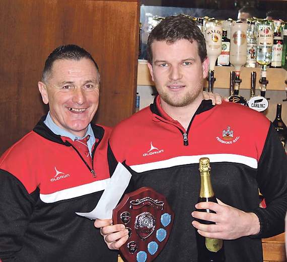 Toby Smith receives his Pembroke Player of the Month award (for November/December) from club chairman Darrell Willington.