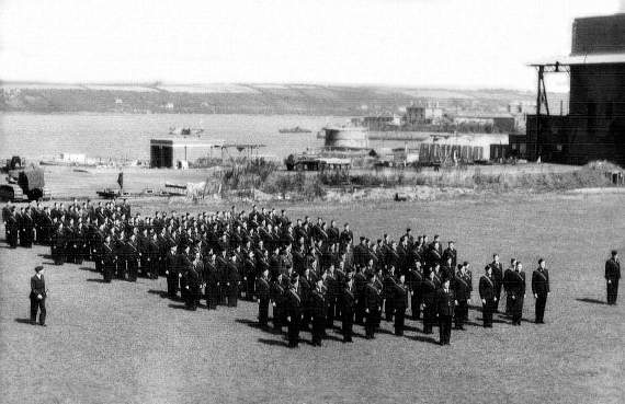 Australian airmen on parade in the RAF Station in 1940 or early 1941. The eastern hangar is to the left with Hobbs Point in the distance. Pic. Sunderland Trust